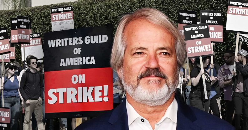 Graham Yost, creator of Silo, pictured against the background of a writers' strike protest with a sign saying "writers guild of America on strike!"