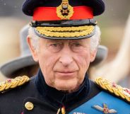 King Charles III wears military dress as he stands amid a crowd preparing for his coronation ceremony