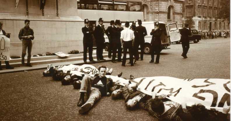 Paul Burston lying on the ground during an ACT UP protest.