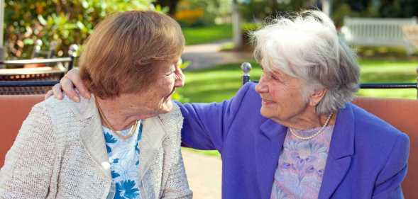 Elderly women looking at each other
