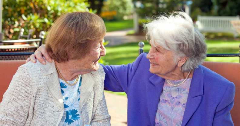 Elderly women looking at each other