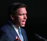 Ron DeSantis speaking infront of a pitch black backdrop.