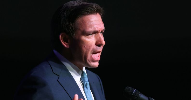 Ron DeSantis speaking infront of a pitch black backdrop.