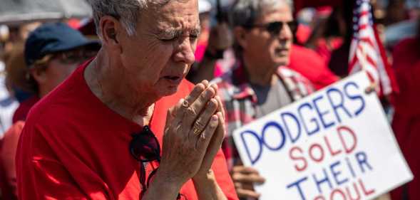 Protester praying outside LA Dodgers game