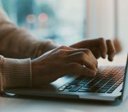 A person typing on a laptop.