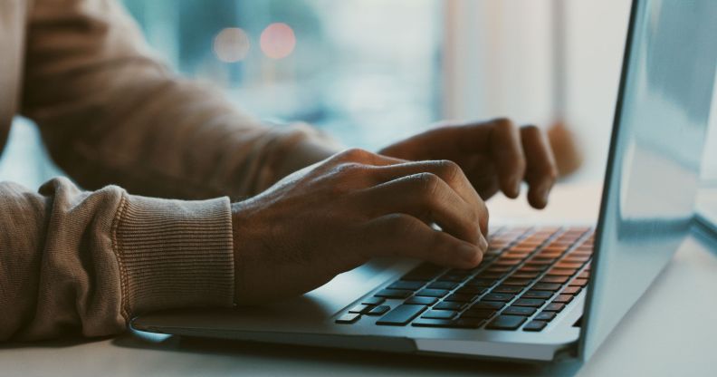 A person typing on a laptop.