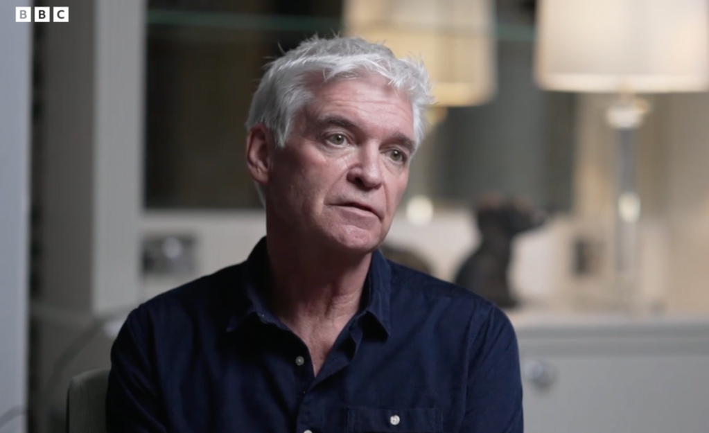 TV presenter Phillip Schofield wears a blue shirt while being interviewed by the BBC in his home.