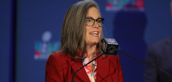 Arizona governor Katie Hobbs speaking into a microphone