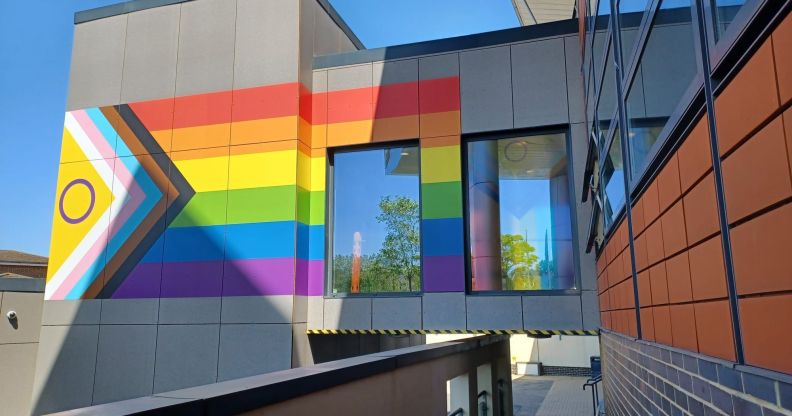 NHS hospital adorned with Progress Pride flag mural