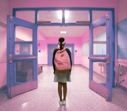 A young person walking down a school hallway