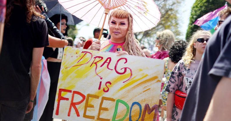 A person holds up a sign reading 'drag is freedom' amid a protest against surging anti-LGBTQ+ bills in the US like Tennessee's drag ban