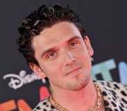 Pop singer Lauv wearing a spotted shirt with short dark hair.