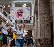 A person holds up a sign reading 'trans justice can't wait' as LGBTQ+ and trans rights advocates protest in the Texas Capitol Building against the wave of anti-LGBTQ+ bills in the state including a gender-affirming healthcare ban for trans youth