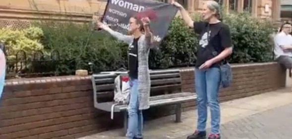 Two people at an anti-trans protest in Lincoln