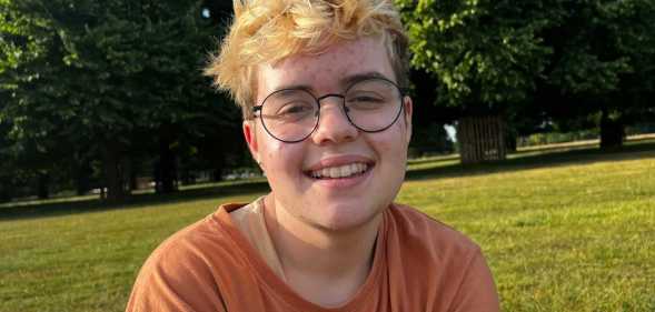 Beckett Seaton-Bailey, a young white transmasc person with bleach blonde hair