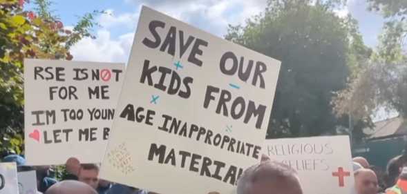 Parents hold signs up at Birchfields Primary School protest in Manchester