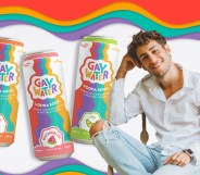 This is a composite image of Spencer Hoddeson, CEO of Gay Water. He is sitting on a chair with his legs cross. Behind him are cans of Gay Water.