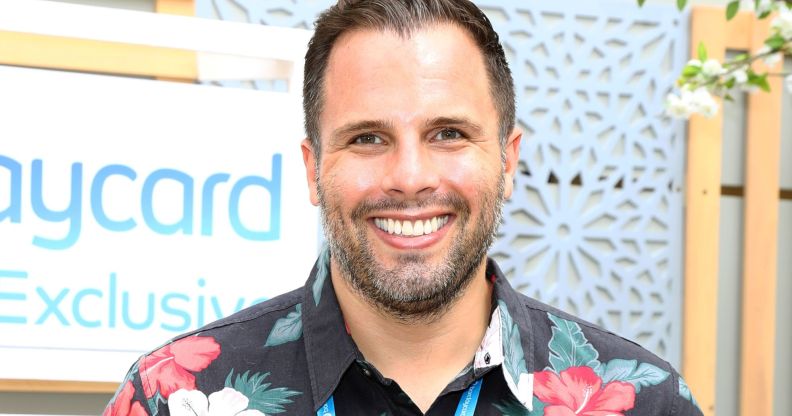 Dan Wootton, in a Hawaiian shirt, smiles towards a camera.