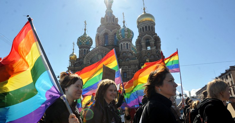 Several activists carry rainbow Pride flags in St Petersburg, Russia