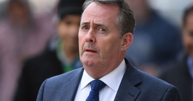 North Somerset MP Liam Fox walks down a busy street.