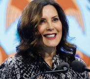 Gretchen Whitmer, Michigan Governor, smiles as she speaks into two microphones.