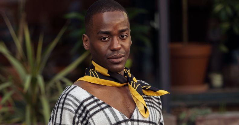 Ncuti Gatwa in a black and white shirt and black and yellow neck tie.