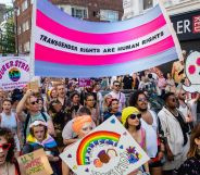 A crowd of people hold up a sign reading "trans rights are human rights" during the 2022 Trans+ Pride event in London.