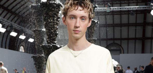 Troye Sivan in a white jumper dress at Paris Fashion Week.