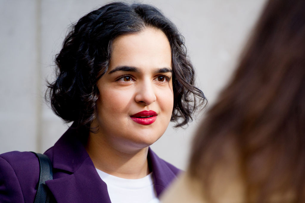 Labour MP Nadia Whittome pictured outdoors doing an interview. She is wearing a purple blazer.