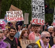 An activist holds up a sign reading 'trans rights saves lives' while others hold up signs denouncing fascism during the London Trans+ Pride march where advocates call for trans and LGBTQ+ people to be safe from persecution