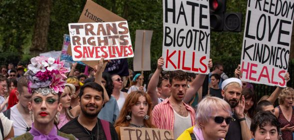 An activist holds up a sign reading 'trans rights saves lives' while others hold up signs denouncing fascism during the London Trans+ Pride march where advocates call for trans and LGBTQ+ people to be safe from persecution