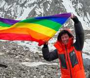 Aidan Hyman waves Pride flag near the summit of the K2 mountain