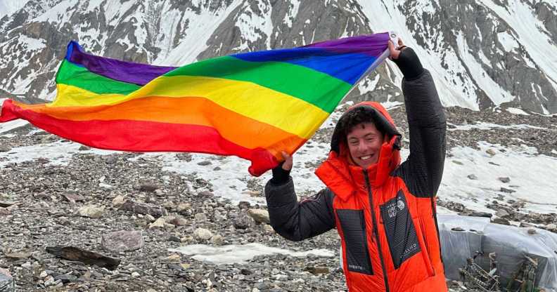 Aidan Hyman waves Pride flag near the summit of the K2 mountain