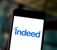 The Indeed.com logo is seen displayed on a smartphone.