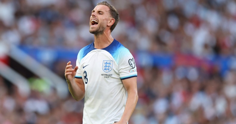 England footballer Jordan Henderson wearing a white and blue strip during a match