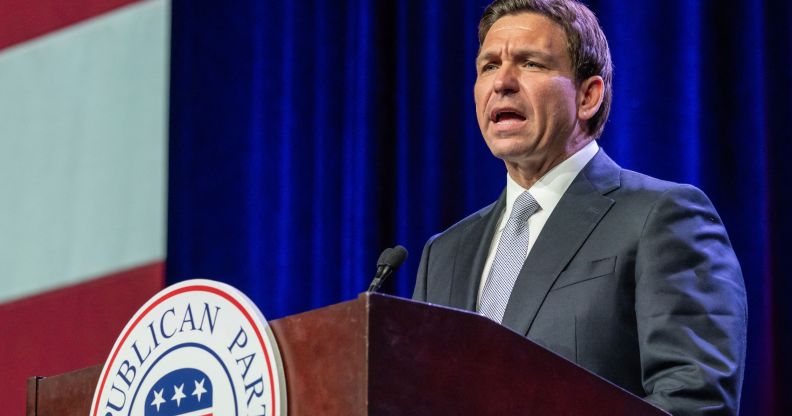 Florida governor Ron DeSantis stands at a podium