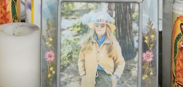 A picture of California store owner Laura Ann Carleton in a frame with flowers set up during a memorial after Carleton was fatally shot by an unidentified man who made "disparaging remarks" about an LGBTQ+ Pride flag outside her store