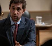 New College of Florida trustee Christopher Rufo speaks to two people during a meeting.