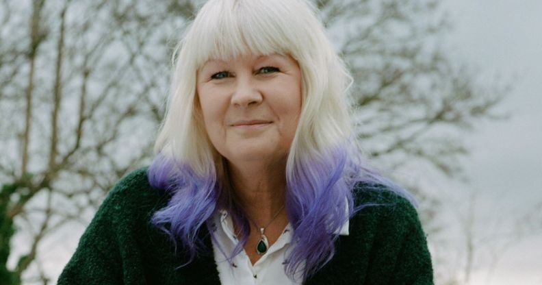 Susie Green outside, wearing a green sweater.