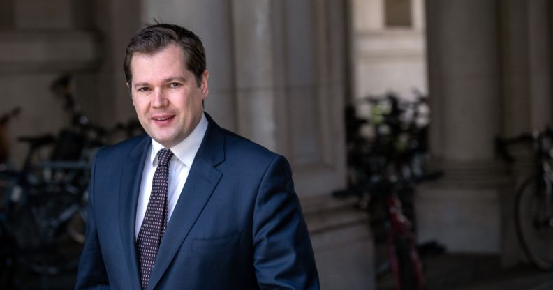 Britain's Minister for Immigration, Robert Jenrick wears a suit and tie