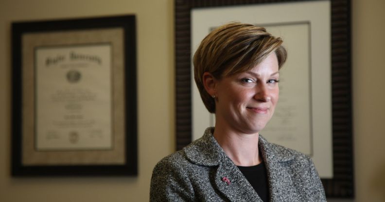 Former Republican Texas state representative Sarah Davis wears a black shirt and dark jacket as she smiles at the camera