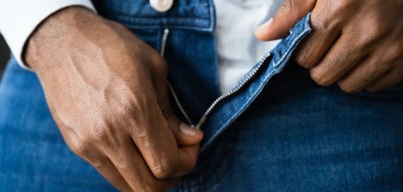 A man unzips his jeans