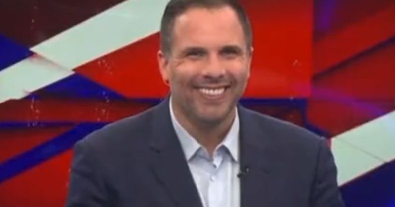 Dan Wootton in the GB News studio smiling.