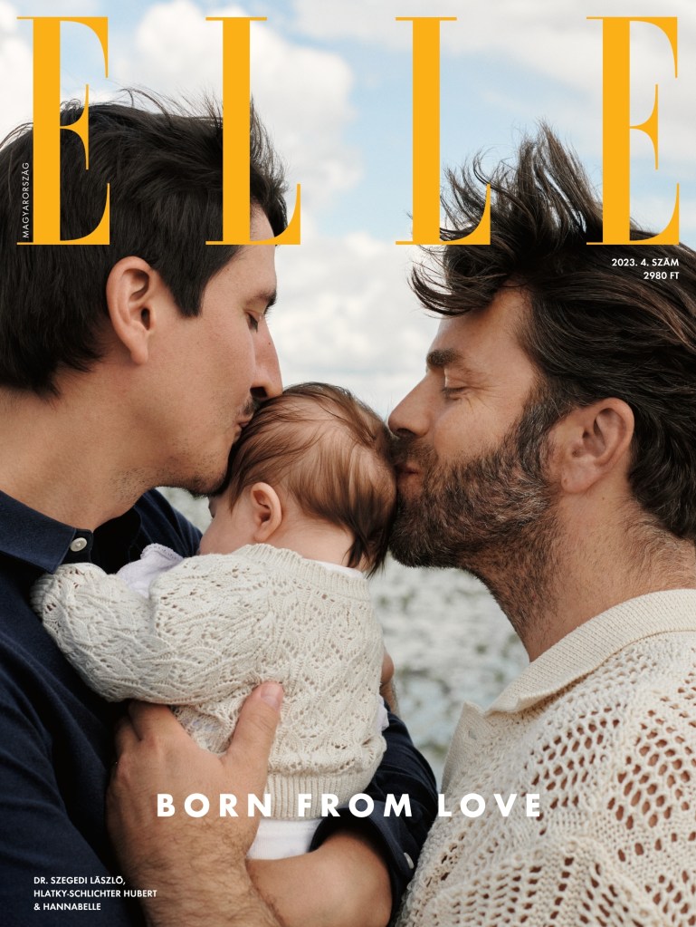 The cover of Elle Hungary, which shows gay dads Hubert Hlatky Schlichter and his neurosurgeon husband Laszlo Szegedi kissing their baby daughter Hannabel on the head