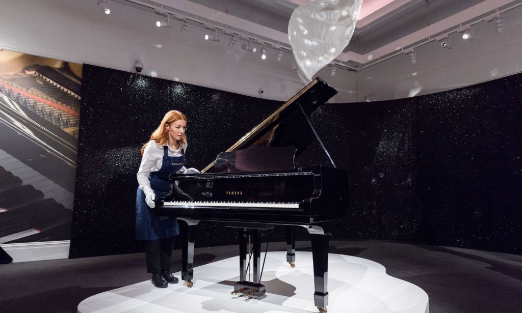 An art dealer with Freddie Mercury's baby grand Yamaha piano.