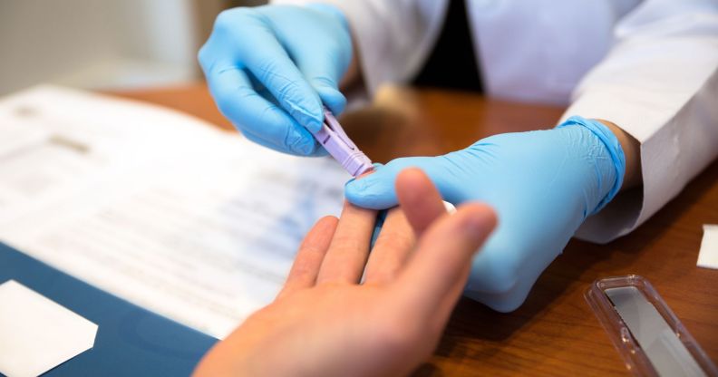 Person getting a finger-prick HIV test