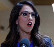 Lauren Boebert speaks into a microphone at a press interview.