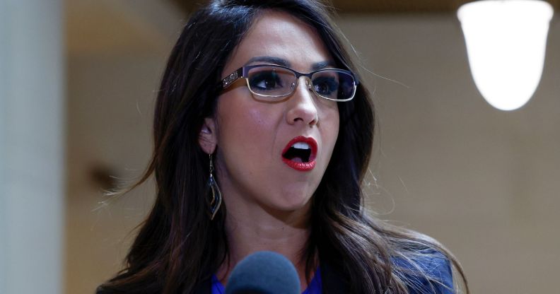 Lauren Boebert speaks into a microphone at a press interview.