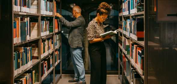 People looking at books in a library.