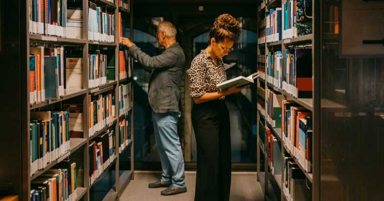 People looking at books in a library.